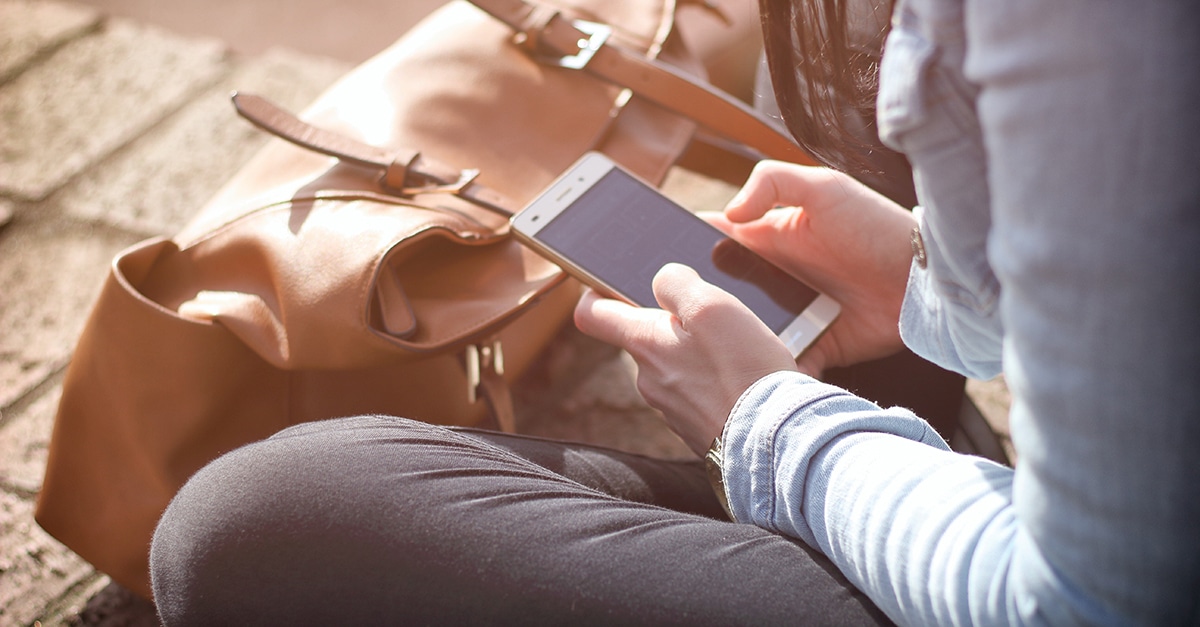 A man sitting with a phone